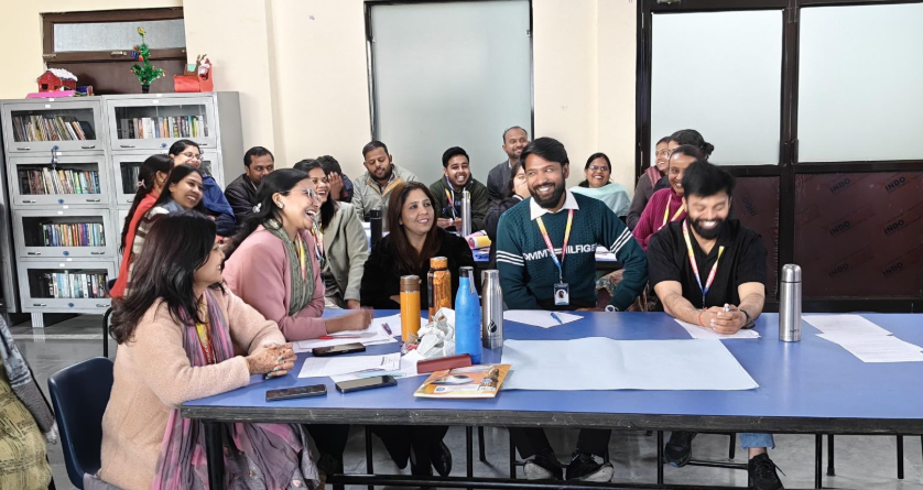 Educators laughing around the table
